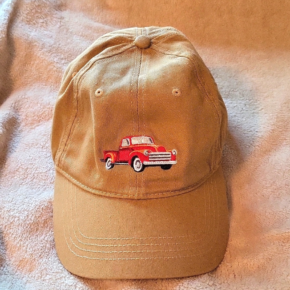 Open Road brand ball cap. Red truck engraved on front.